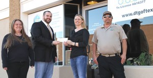 Landon Lambert (second from left) accepts a check for $1,980.80 from CEDC Executive Director Chandra Eggemeyer Monday. Also shown here are Tammy Sparks and Will Jordan of Texas Panhandle CyberMedics. Enterprise Photo / Roger Estlack